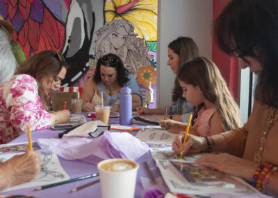 Multiple guests enjoying peaceful time drawing Annie's coloring books inside Vibras at Doral.